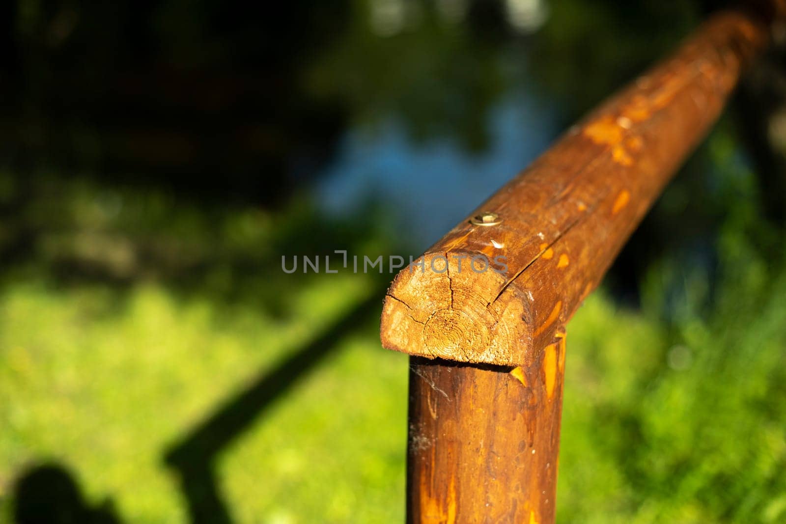 Hedge made of wood in countryside. Barrier made of logs. Fence on farm. Brown log.