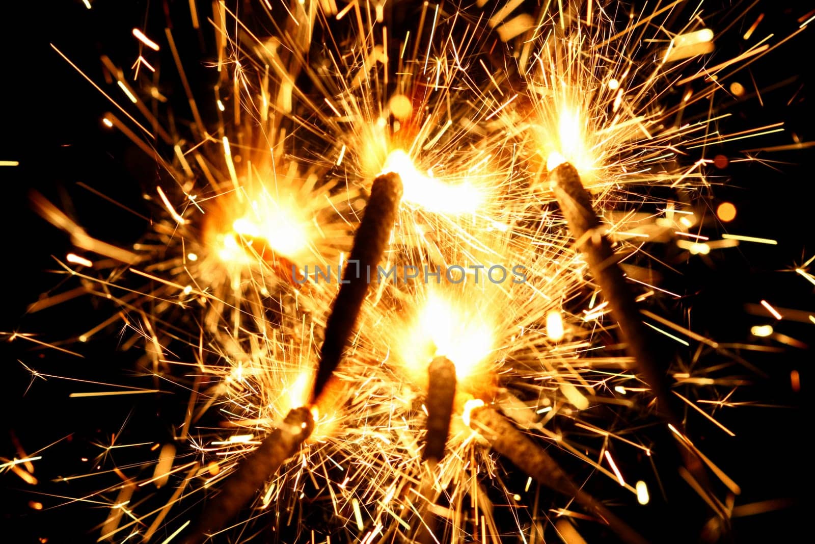yellow sparkler holiday background on black