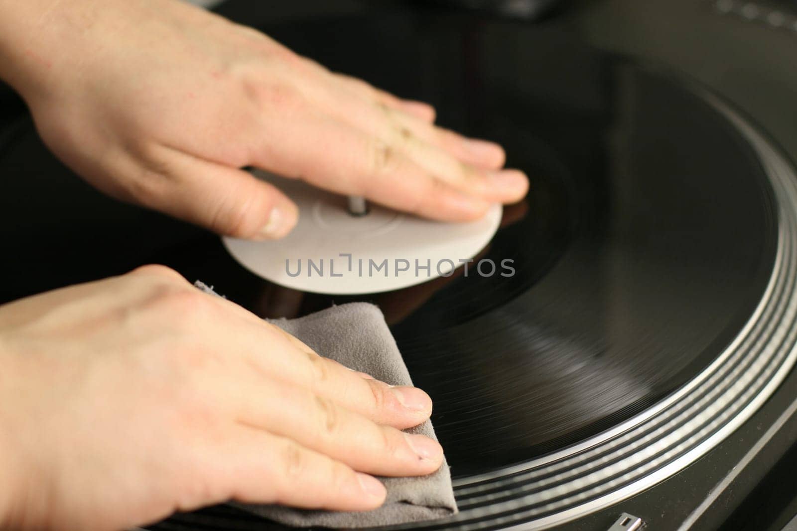 scratch battle of dj playing on his vinyls hand on