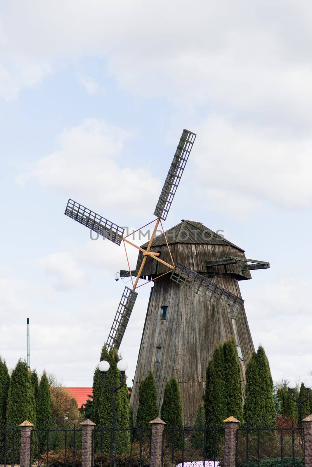 Old wooden wind mill in on sunny day. Old traditional Dutch mill.