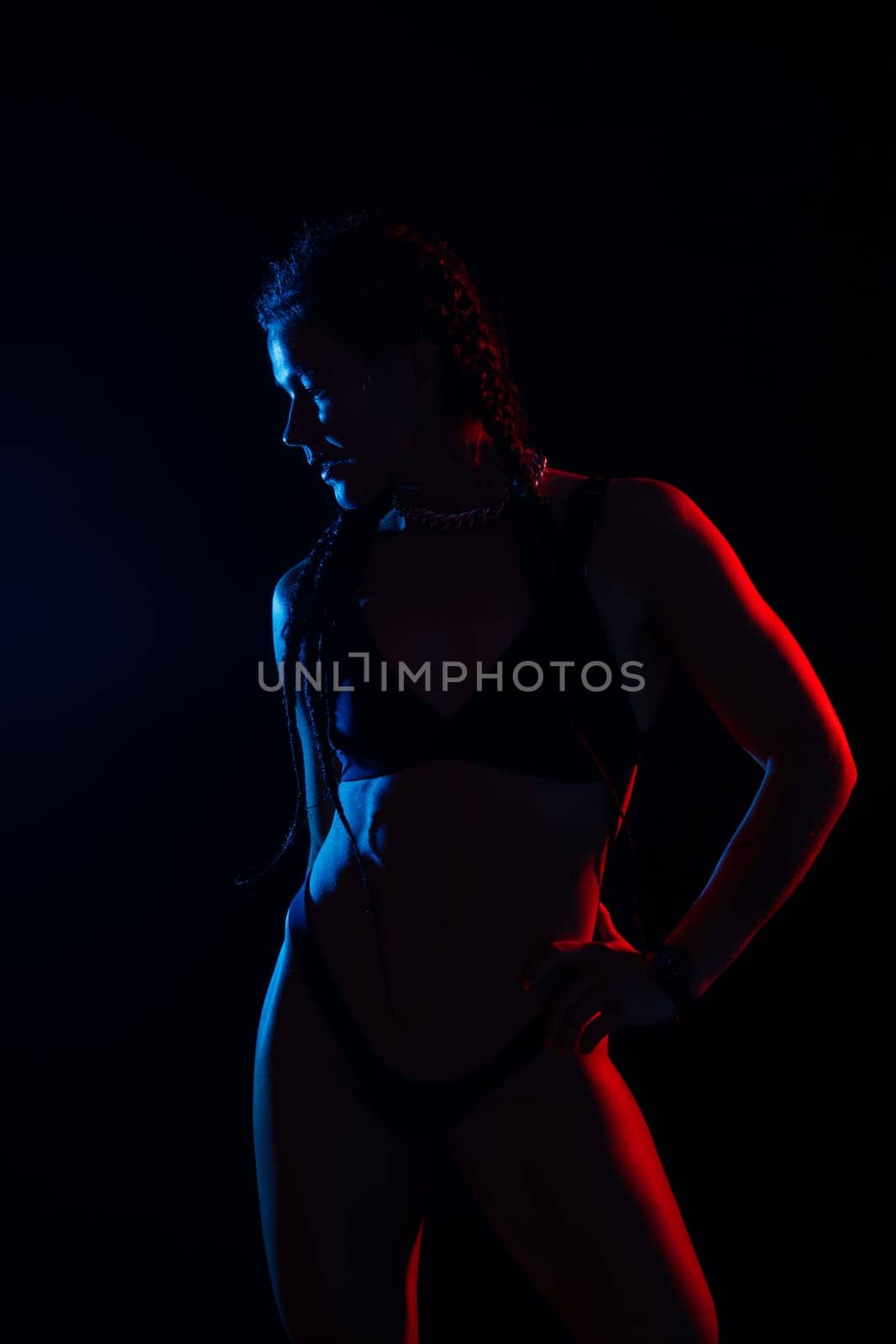 Beautiful seductive woman in a black lingerie. Carefree model with perfect body. Hot tanned female