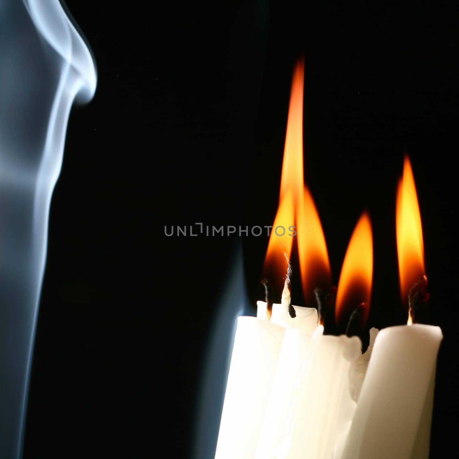 sacred candles in dark on black background