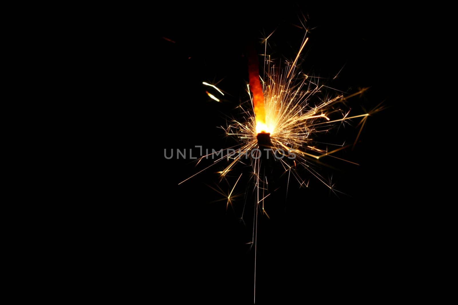 yellow sparkler holiday background on black