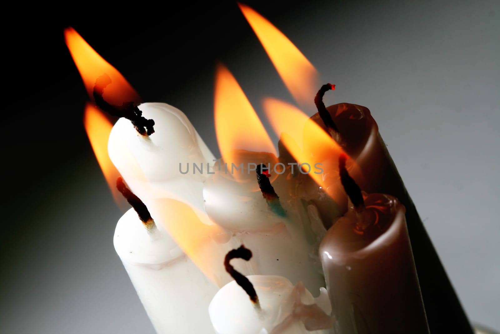 sacred candles in dark on black background
