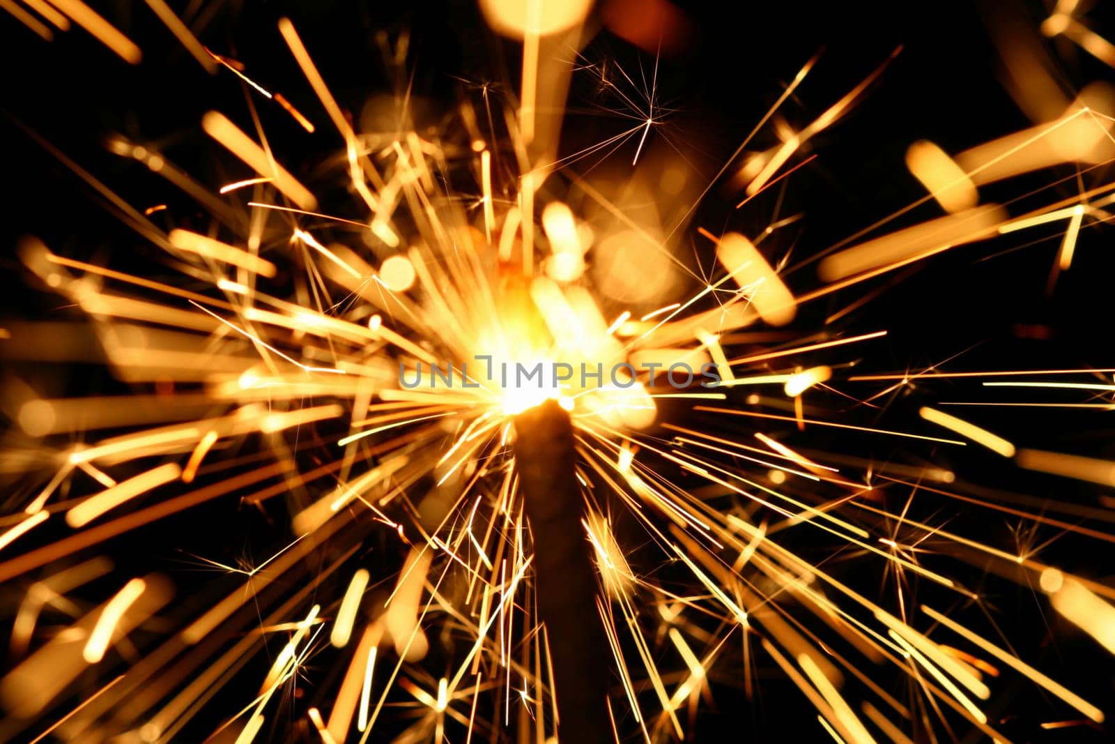 yellow sparkler holiday background on black