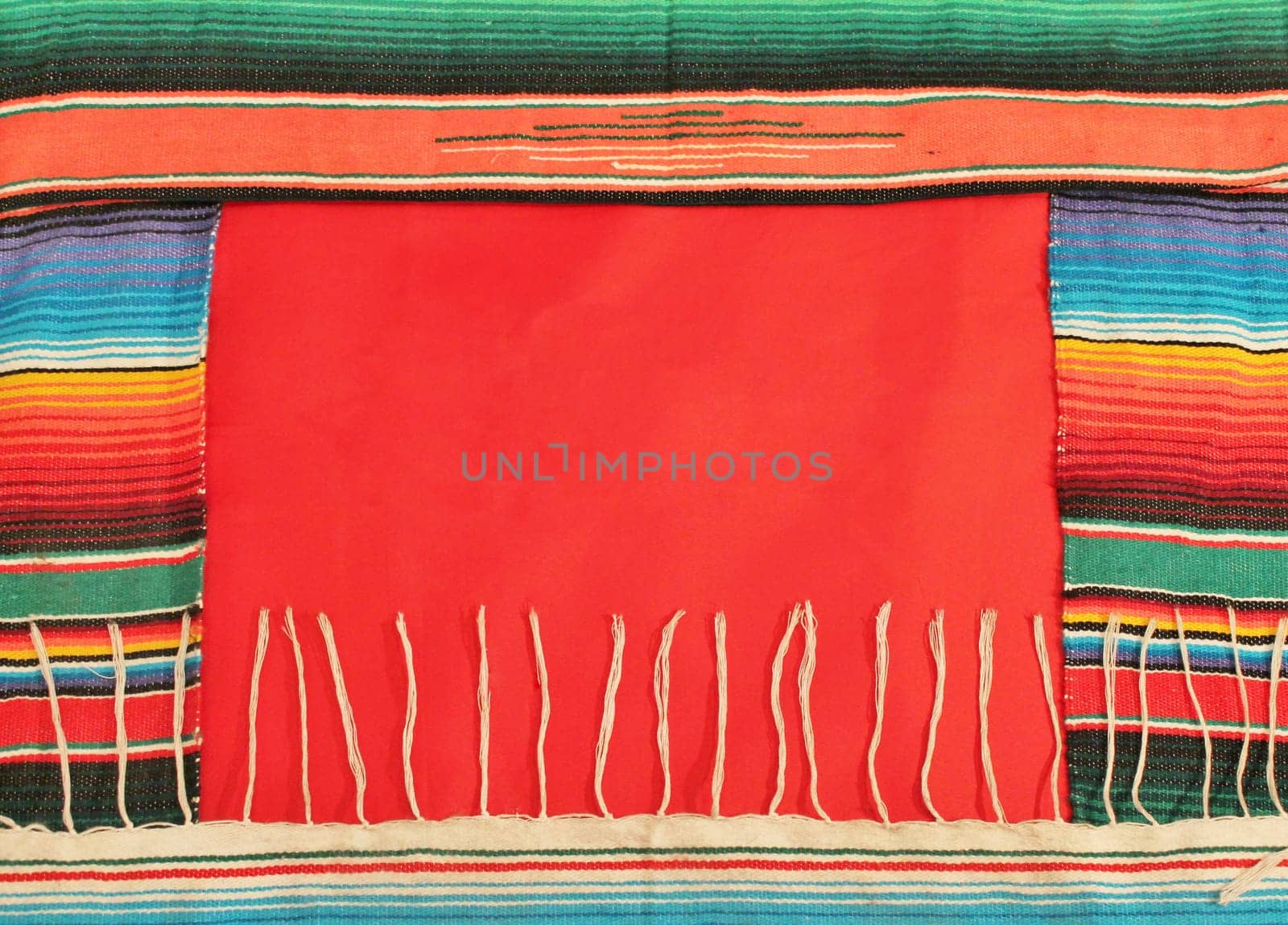 Traditional Mexican fiesta poncho rug in bright colors with sombrero background with copy space