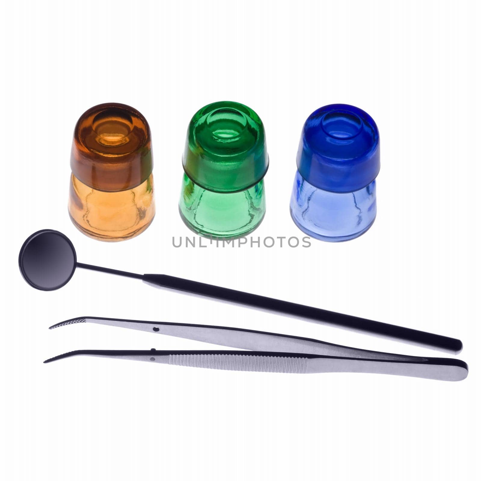 Dental tools and flasks on white background