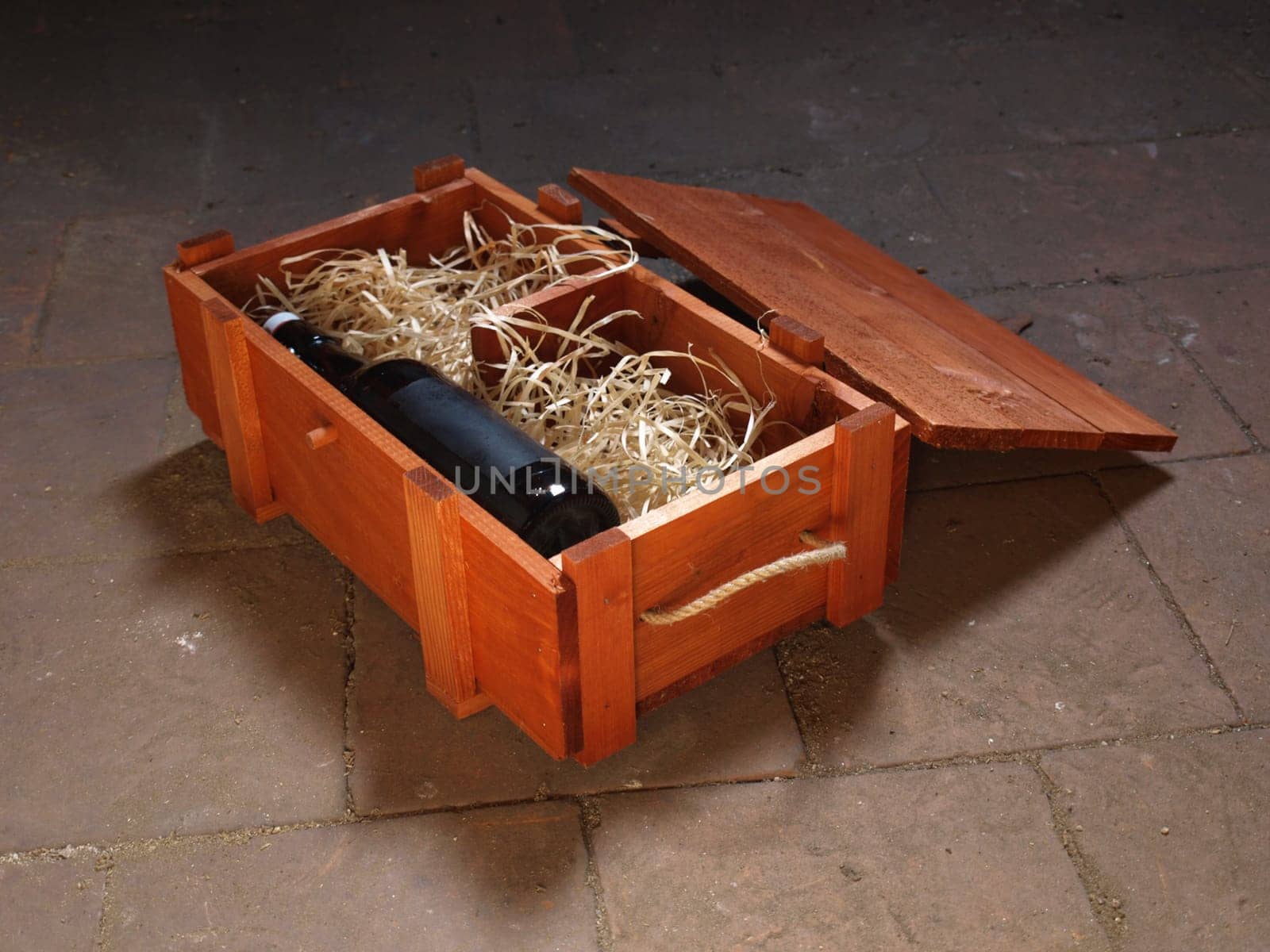 Old bottle of wine stored in wooden box