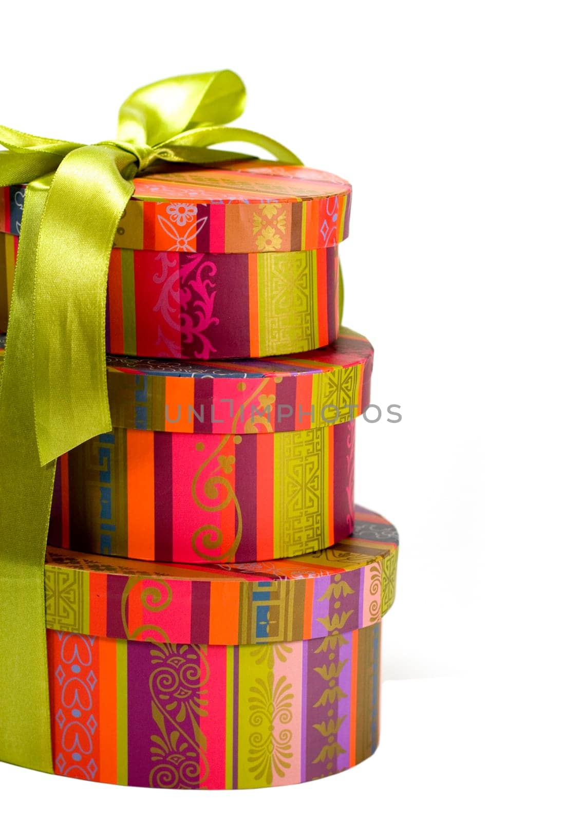 pyramid of colorful gift boxes with green bow on white background