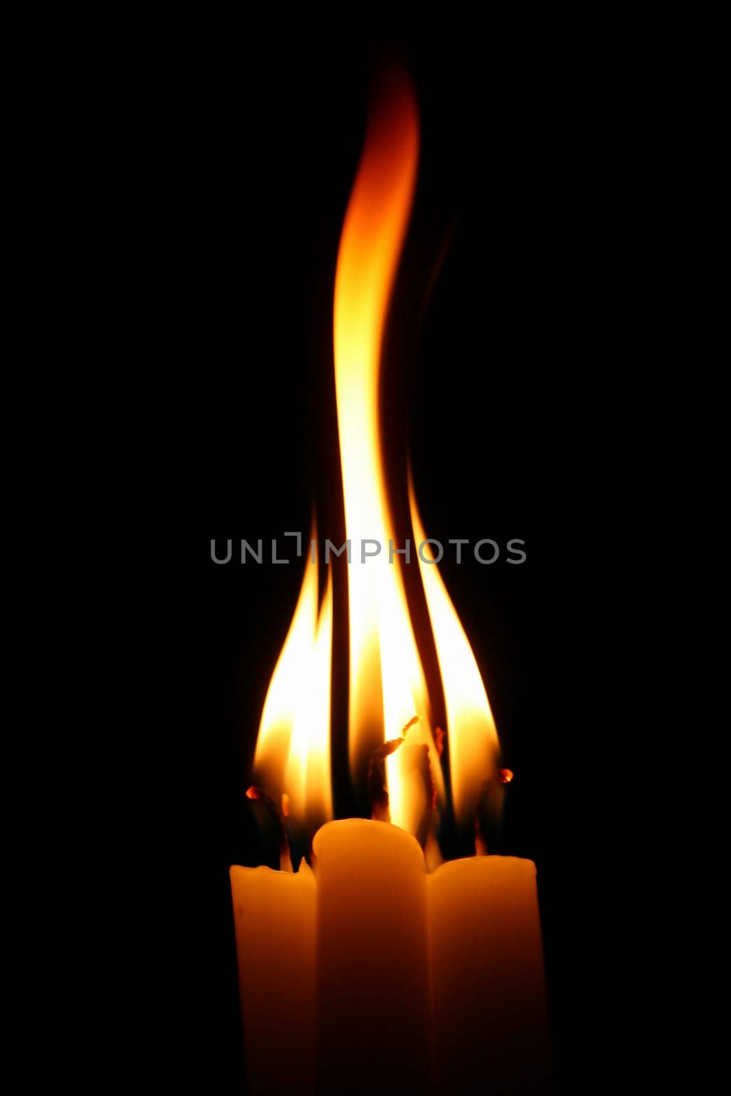 sacred candles in dark on black background