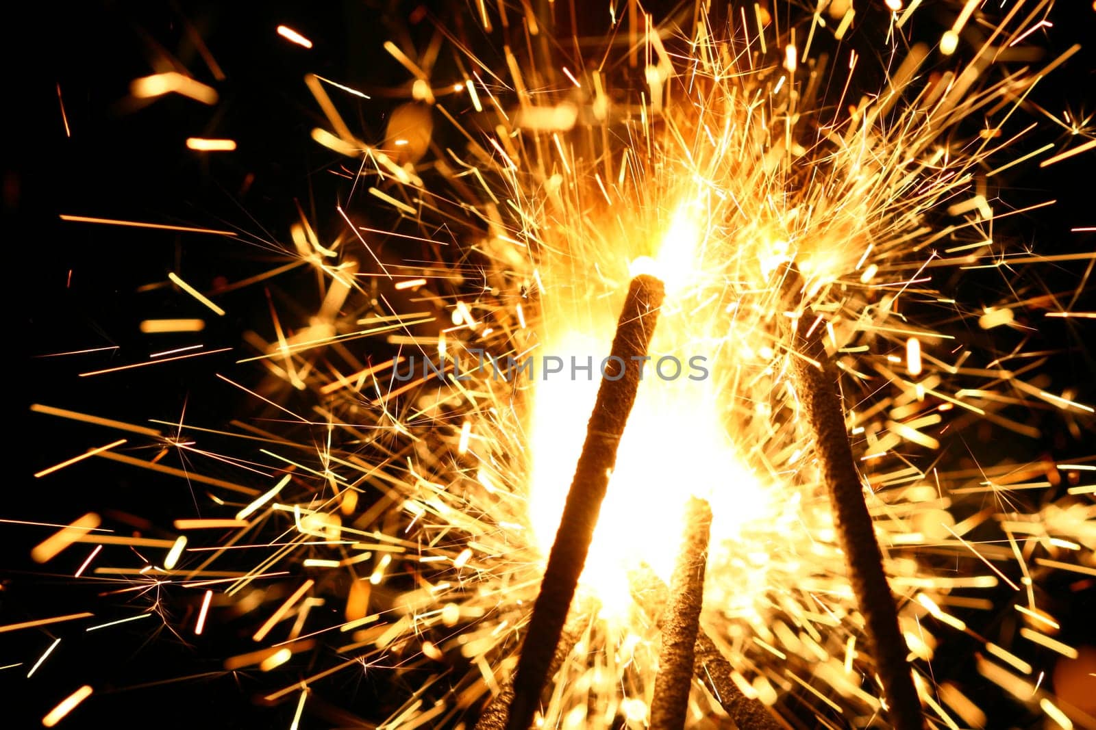 yellow sparkler holiday background on black