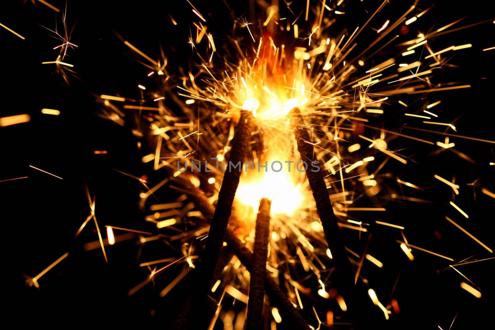yellow sparkler holiday background on black