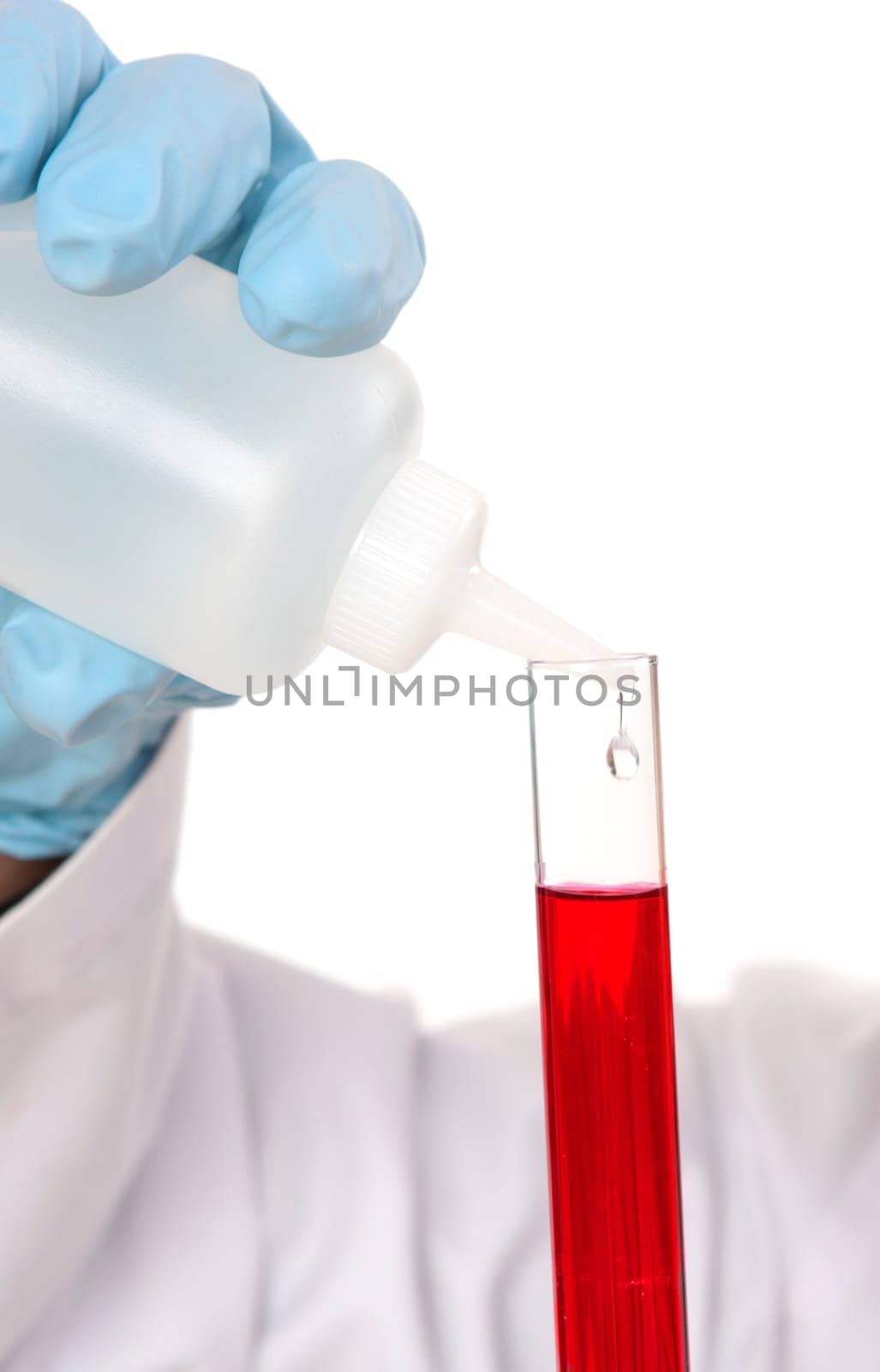 Test tube and dropper bottle with liquid.