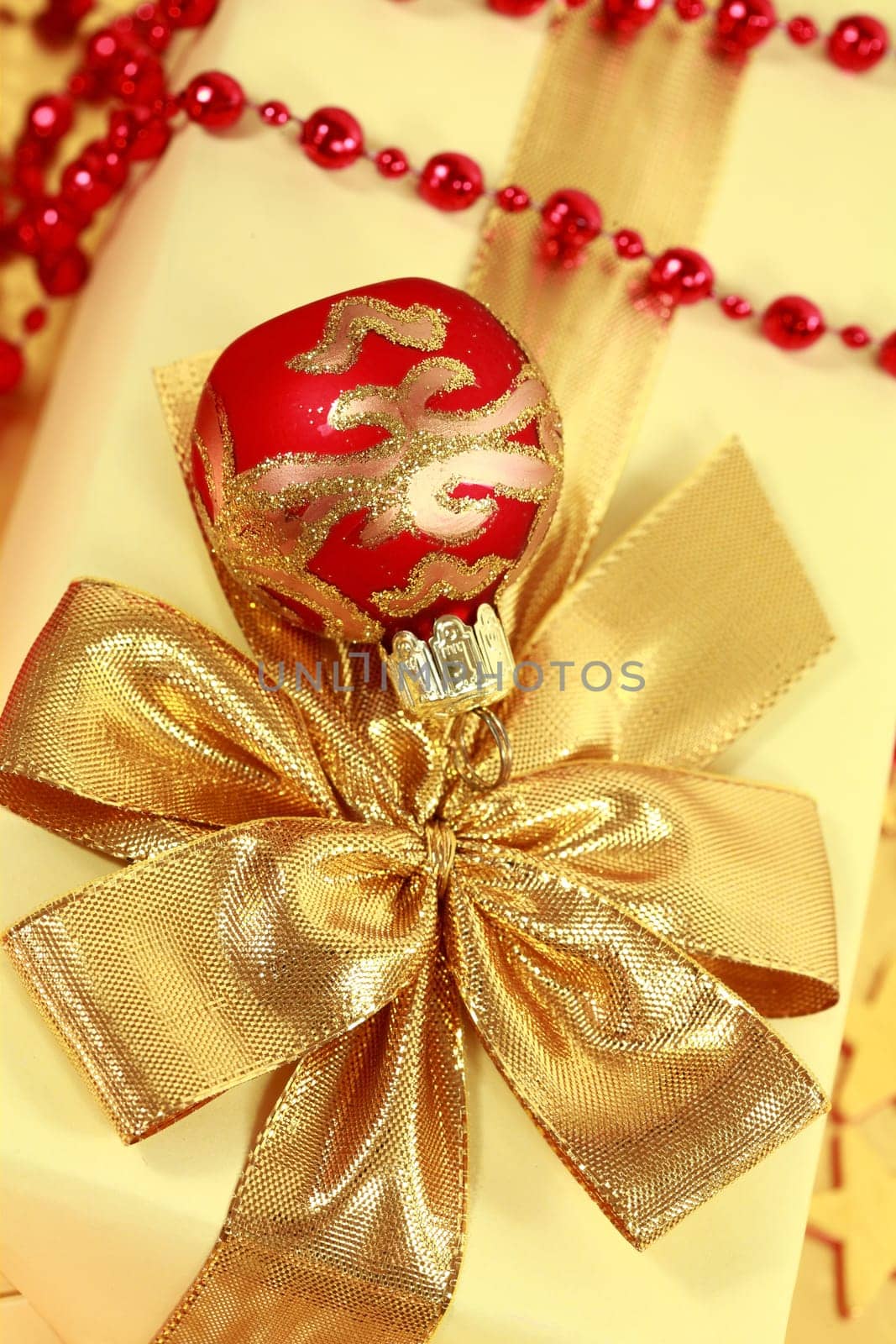 Christmas present with ball in golden and red tone