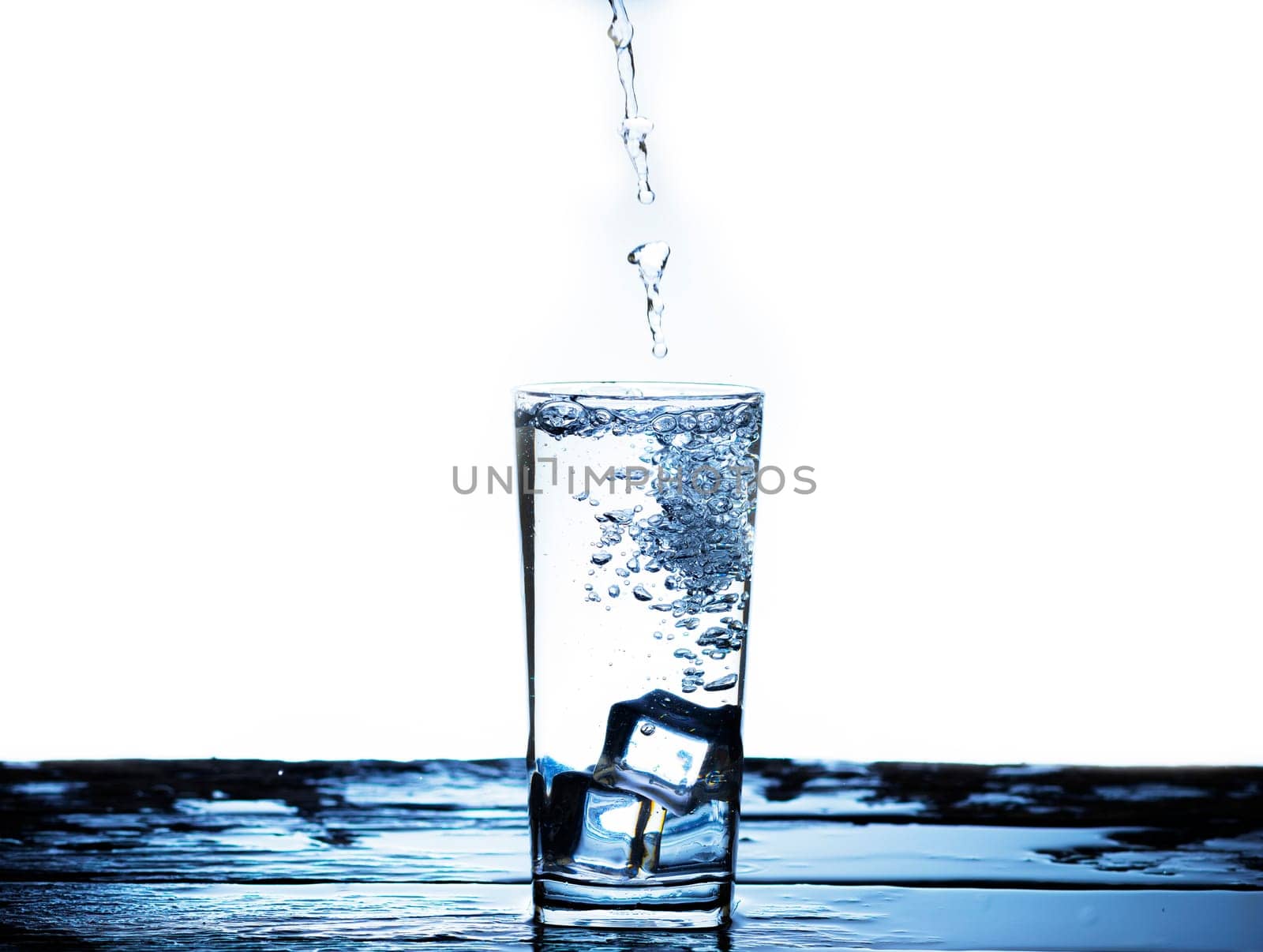 The image of pouring drinking water, into a glass, that makes one feel refreshed on blurred white background, Splashing water, Sparkling water
