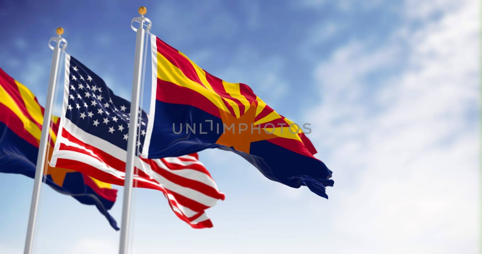 The flags of Arizona and United States waving in the wind on a clear day. Arizona is a state in the Southwestern US. US federate state. 3d illustration render. Selective focus. Fluttering textile