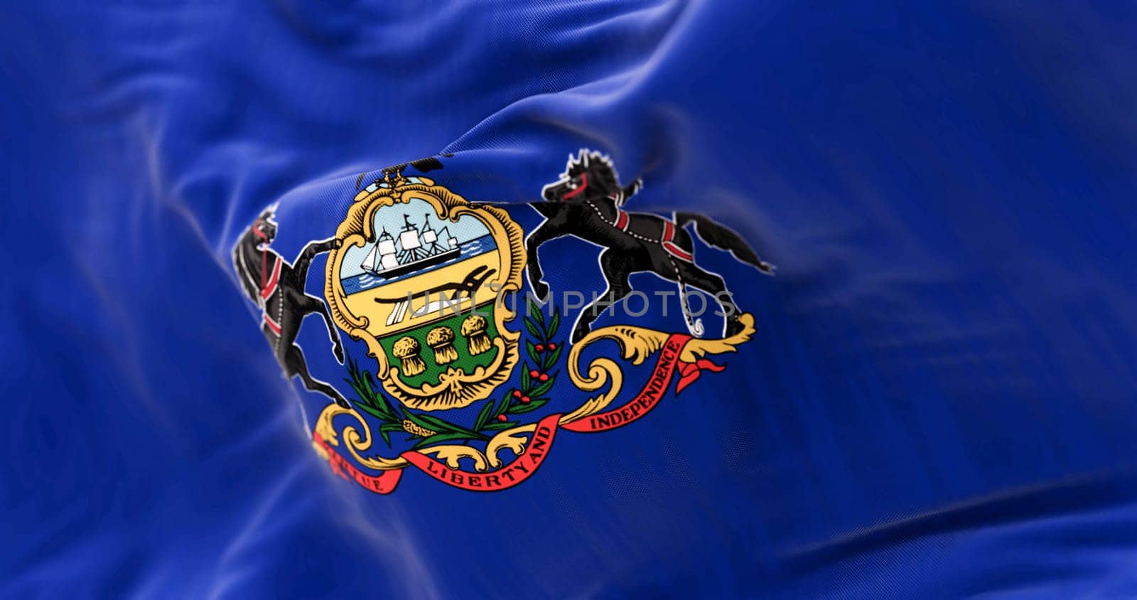 Close-up of Pennsylvania state flag waving. Blue field with state coat of arms: shield between horses, eagle on top. 3d illustration render. Textured background. Selective focus. Fluttering textile