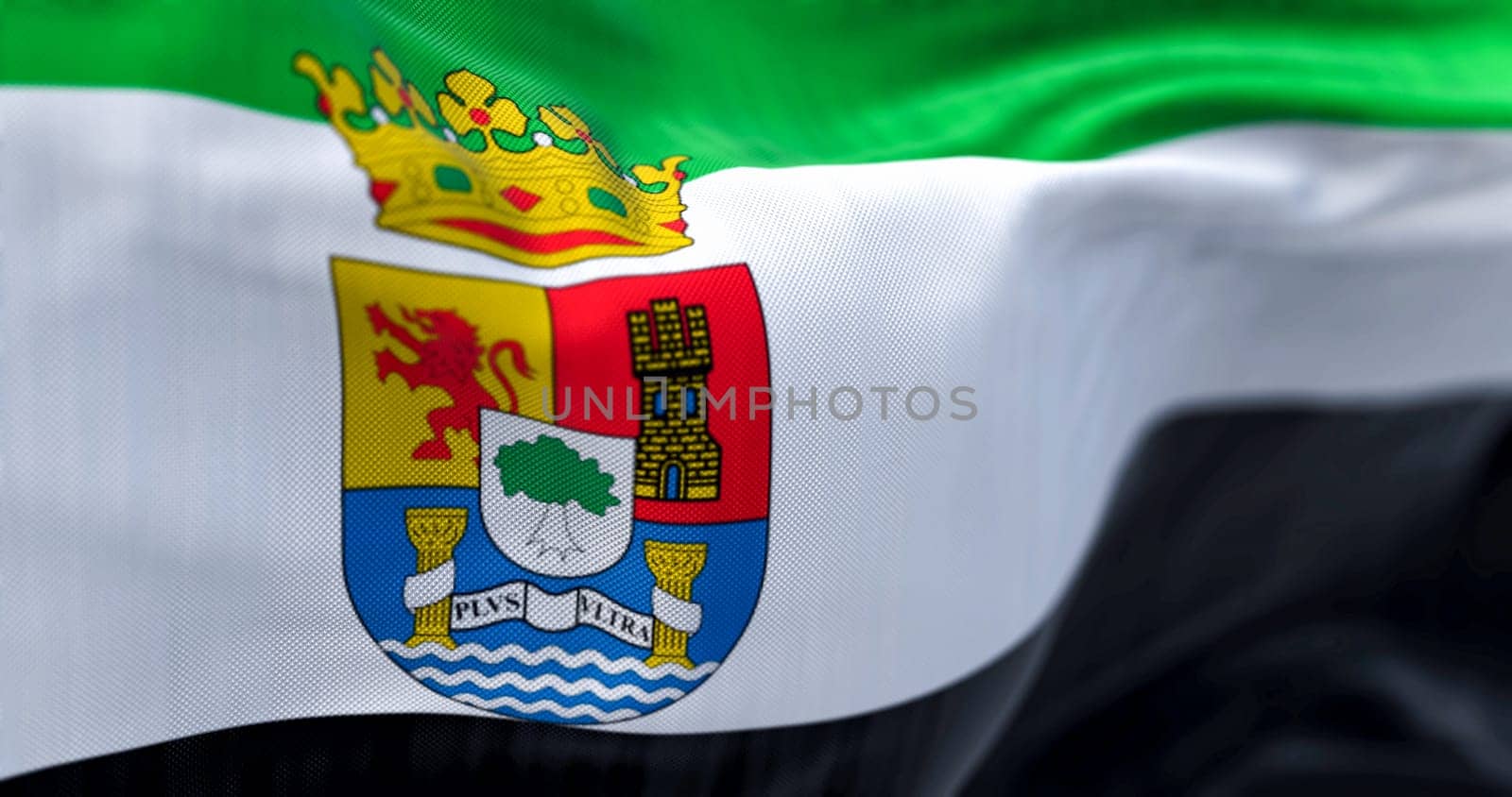 Detail of the Extremadura flag waving. Autonomous community of Spain. Green, white, black stripes. State flag has coat of arms. 3d illustration render. Selective focus. Close-up. Fluttering textile