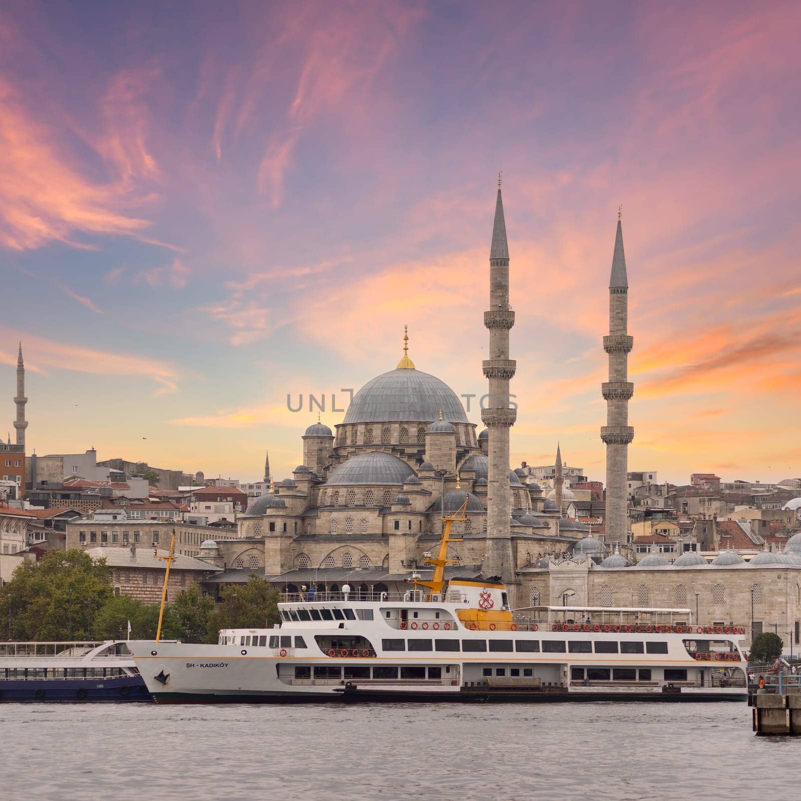 Istanbul city view from Galata Bridge at Eminonu overlooking the Golden Horn with ferries, ferry terminals, and Rustem Pasha Mosque before sunset, Istanbul, Turkey