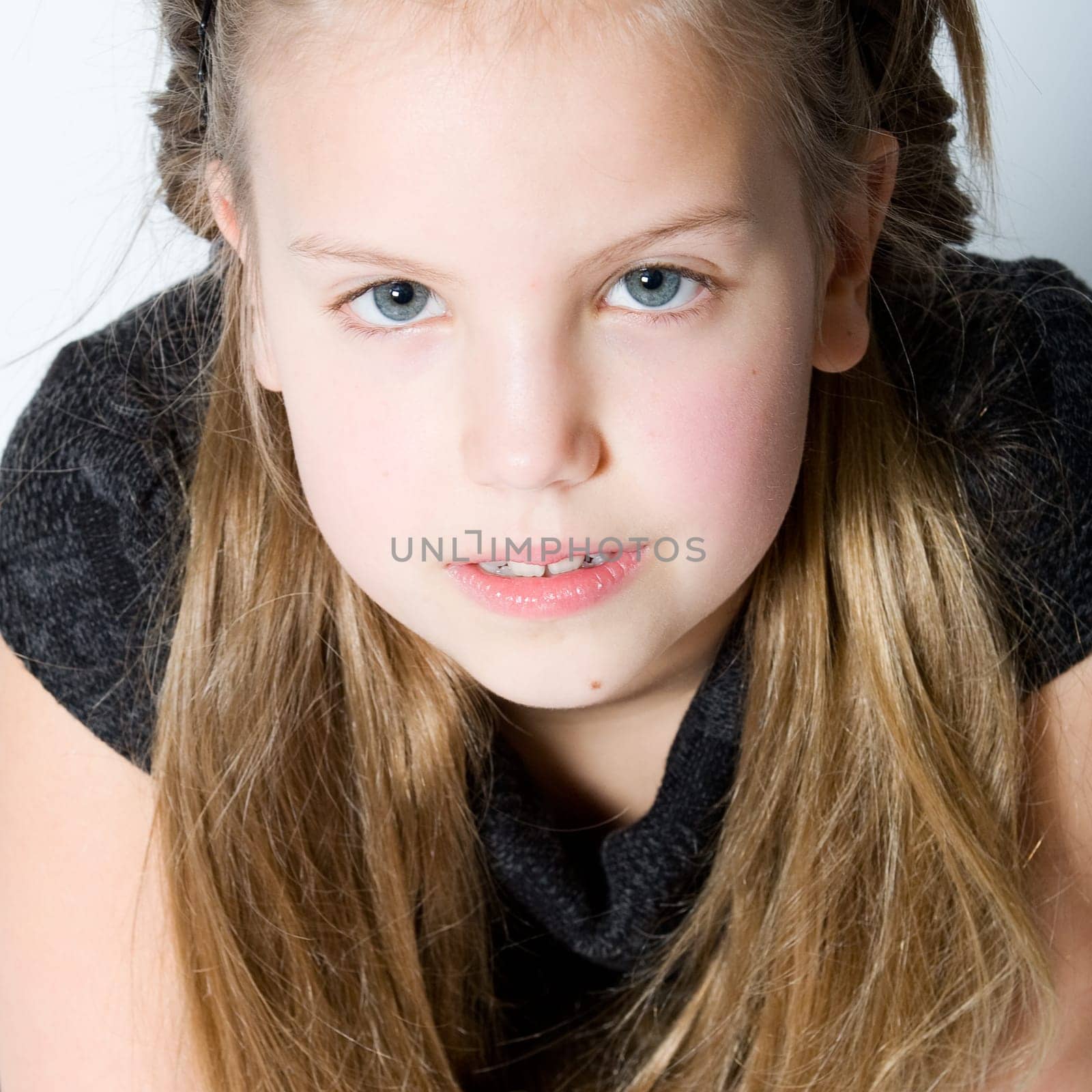 Studio portrait of a blond child making eye contact
