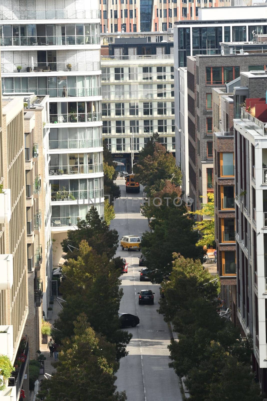 Vertical aerial view of the Am Kaiserkai avenue buildings and vehicles on a sunny day