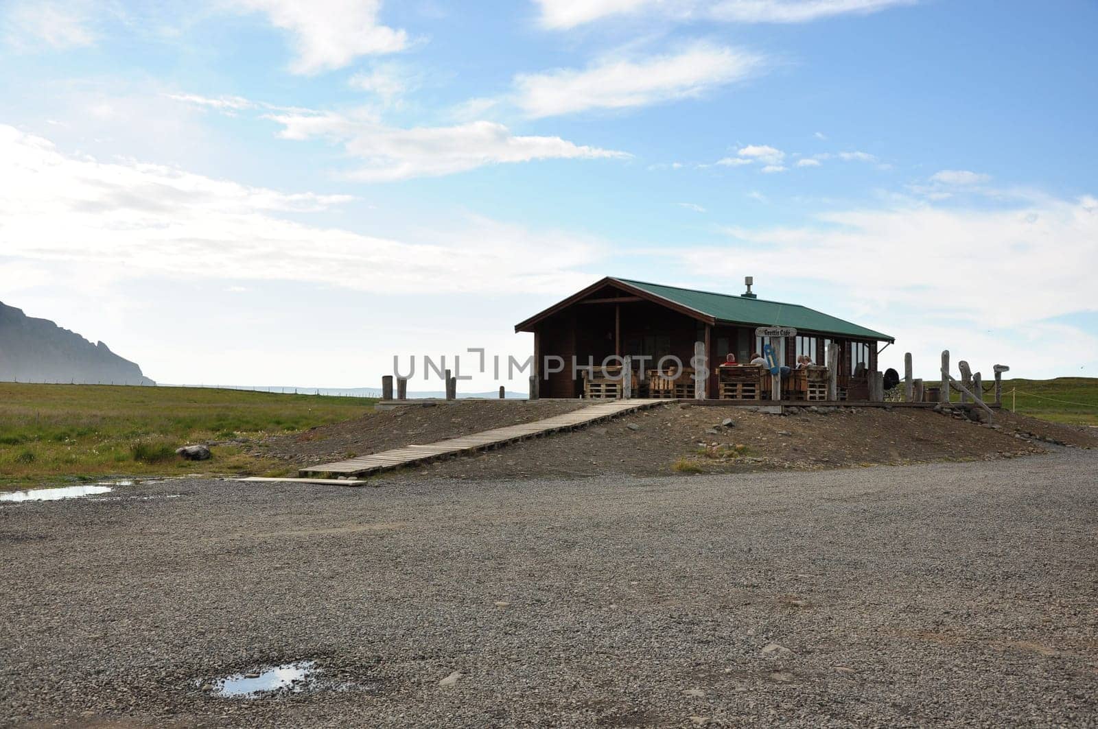 View of a house in a field on a beautiful day in Iceland