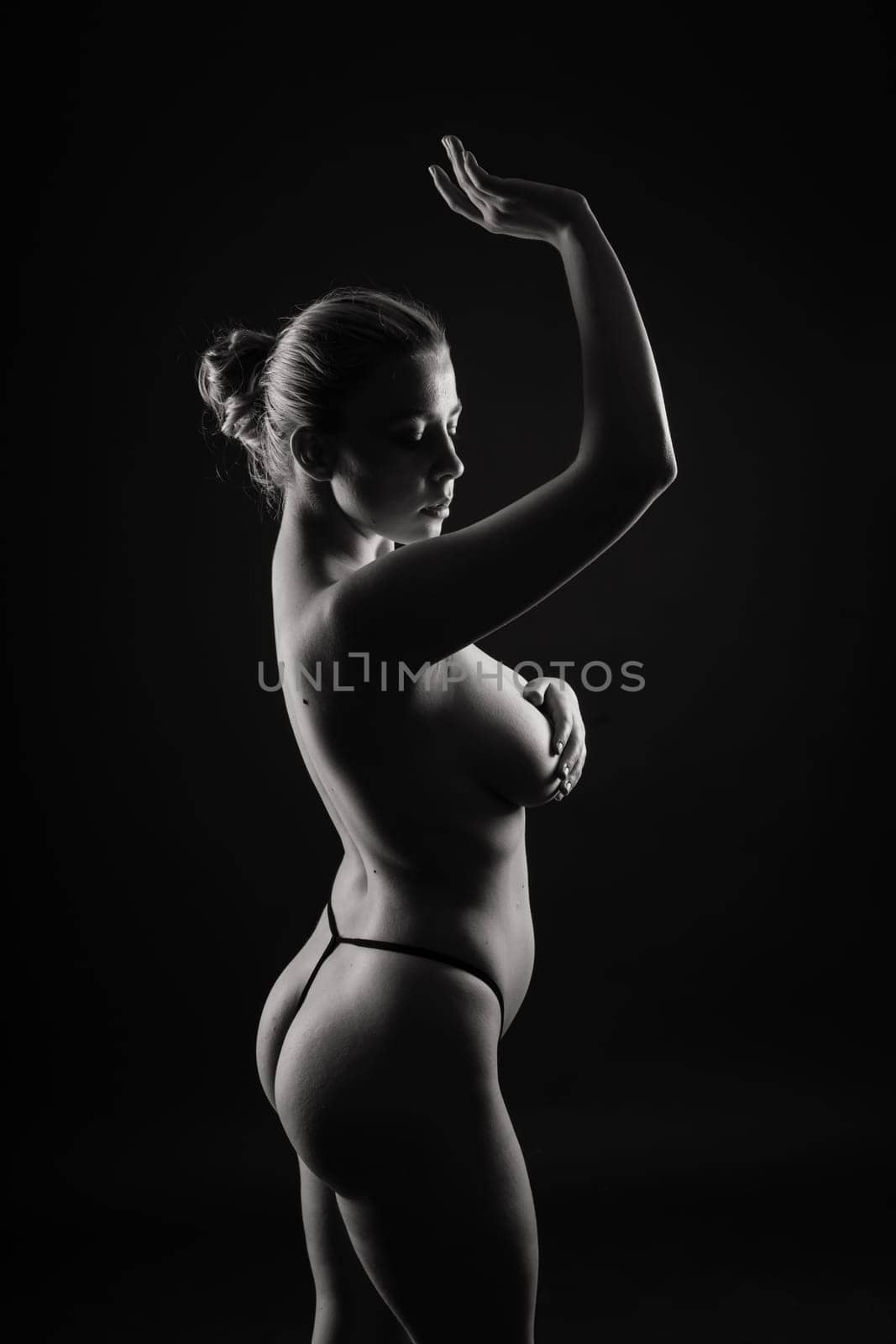 Happy plump body positive blond haired lady poses topless