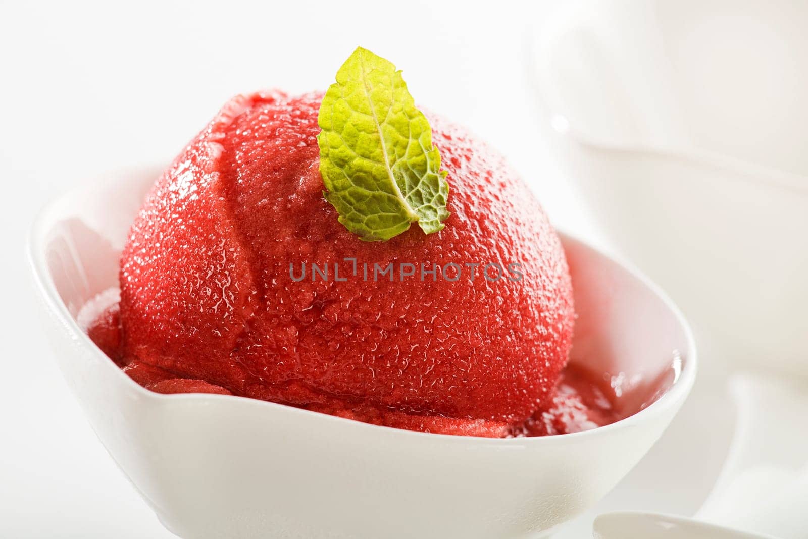 Fresh fruit sorbet in white bowl close up shoot