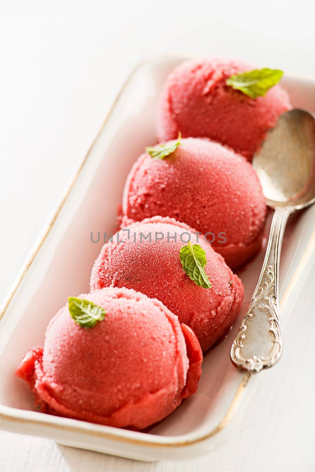 Fresh fruit ice cream balls in white plate.