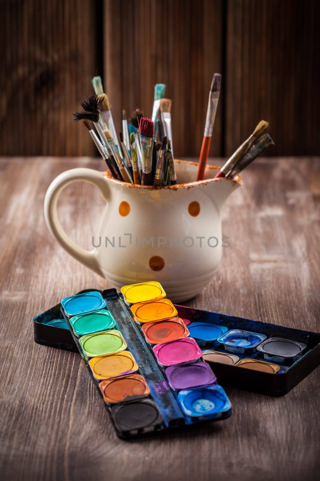 Different used brushes, colours and watercolours
