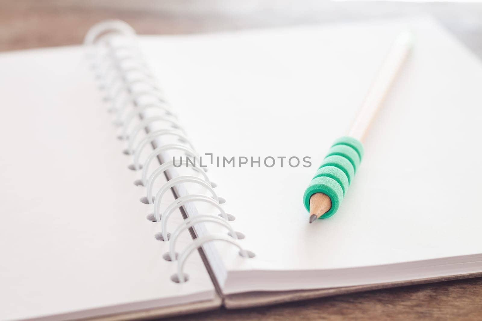 Pencil on open blank notebook, stock photo