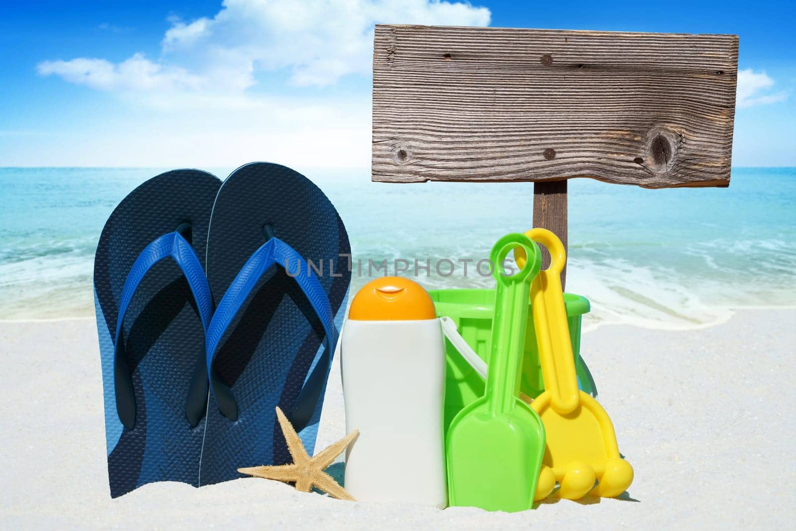 Flip flops,sunmilk,toys and empty wooden sign