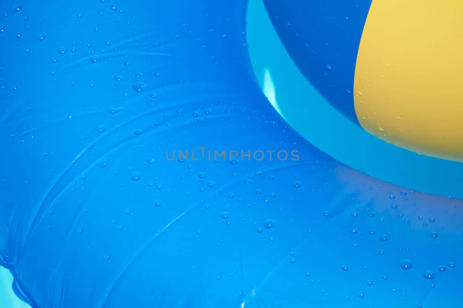Close-up water polo and bath tyres in the paddling pool