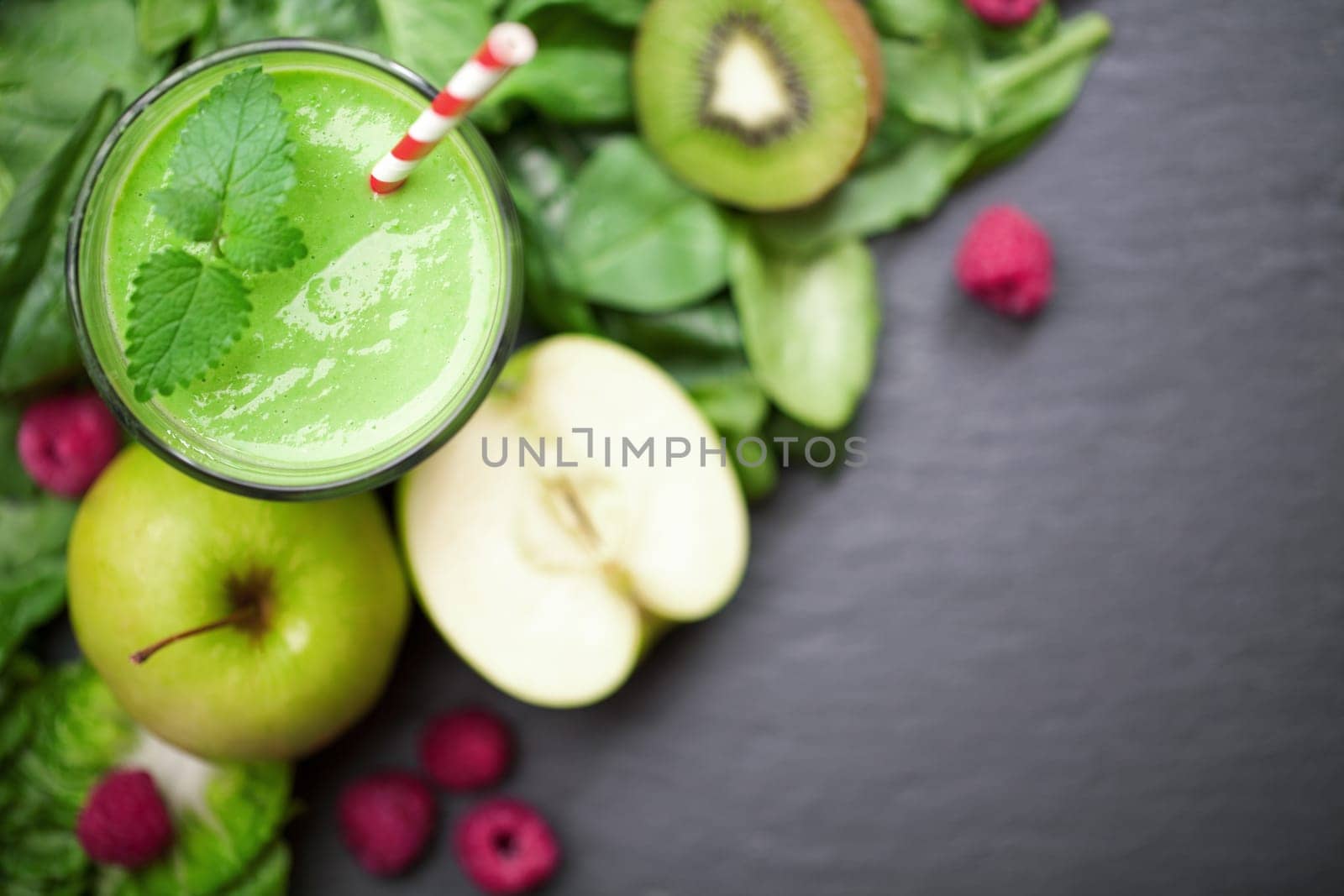 Smoothie green with fruit and vegetables on a chalkboard background