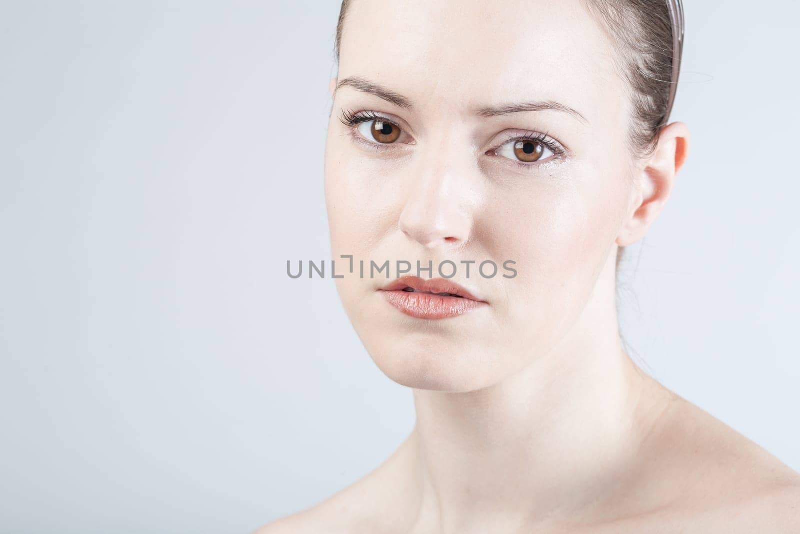 a young woman looks sadly and thoughtfully into the camera
