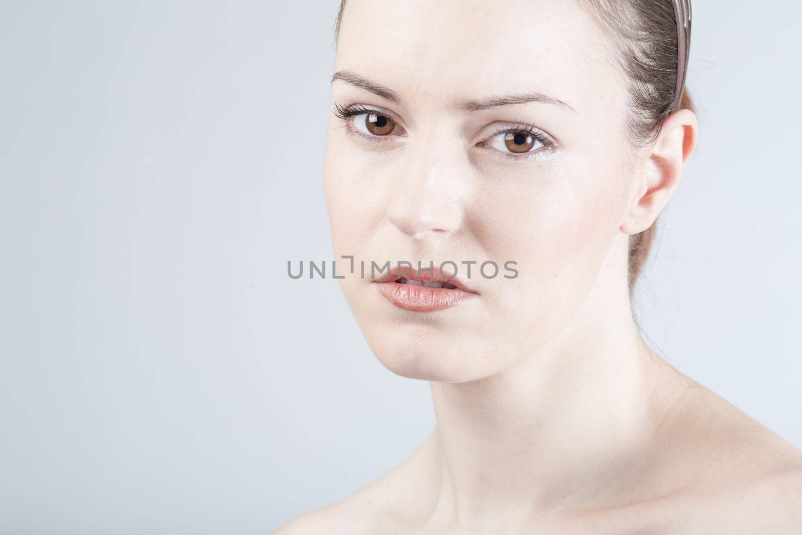 a young woman looks sadly and thoughtfully into the camera