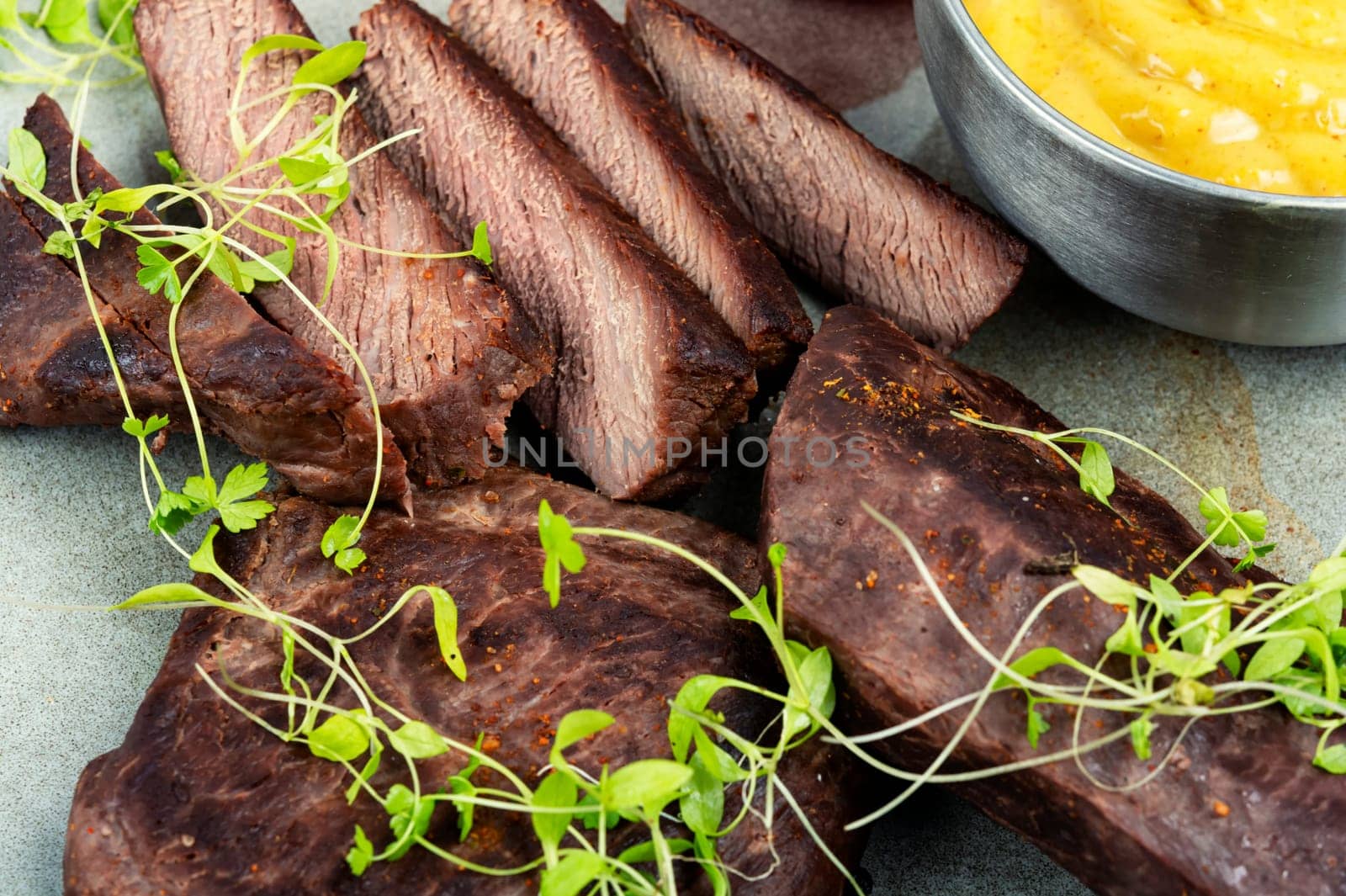 Delicious ostrich meat steaks on the plate. African cuisine.