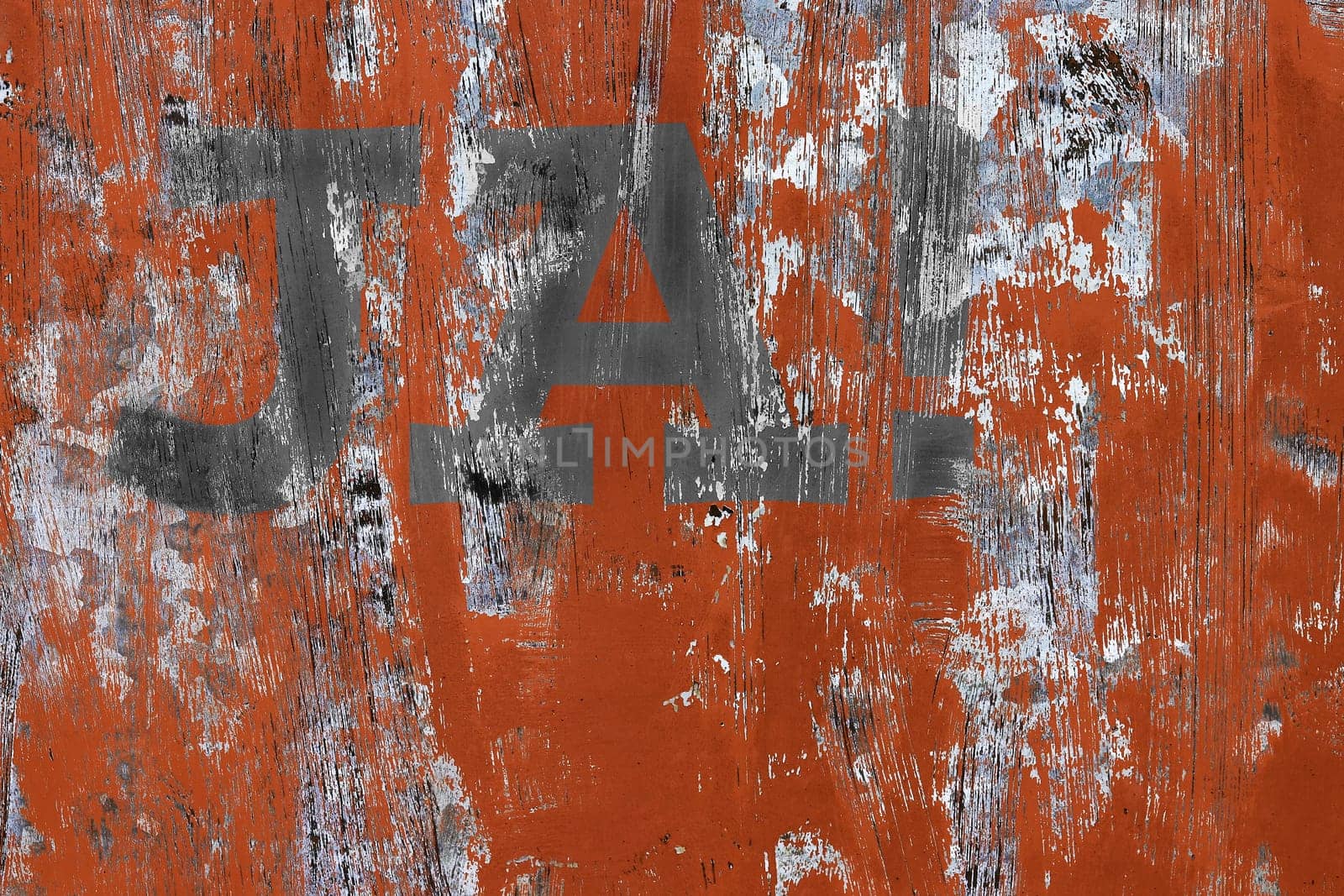 On a weathered red and gray wall is written YES