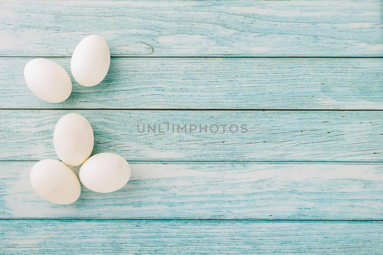 Happy Easter Day Concept. Overhead of holiday banner background design white easter eggs on blue wooden background with empty copy space, celebration greeting card