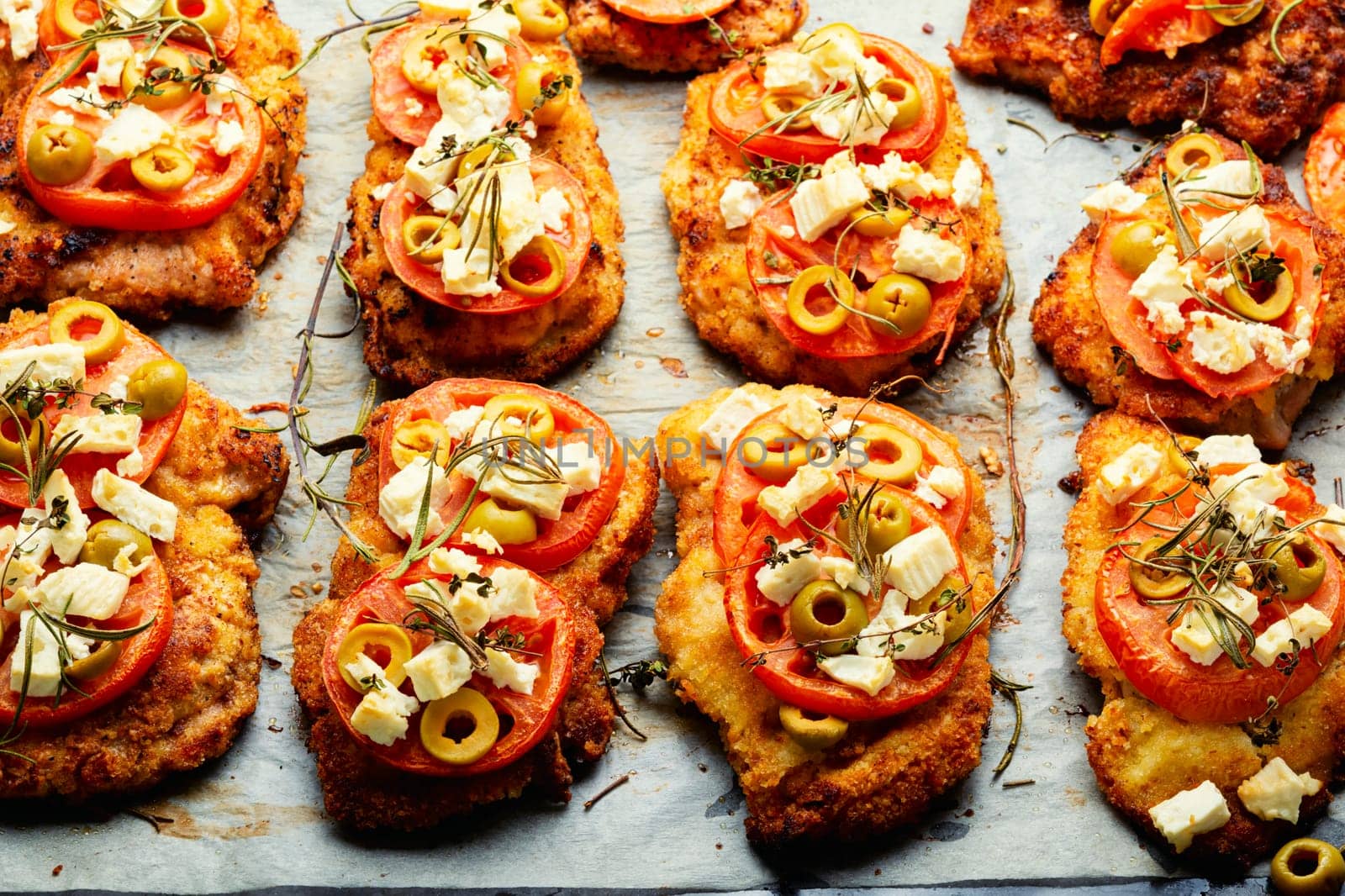 Chicken chops with tomato, olives and cheese. Rustic style
