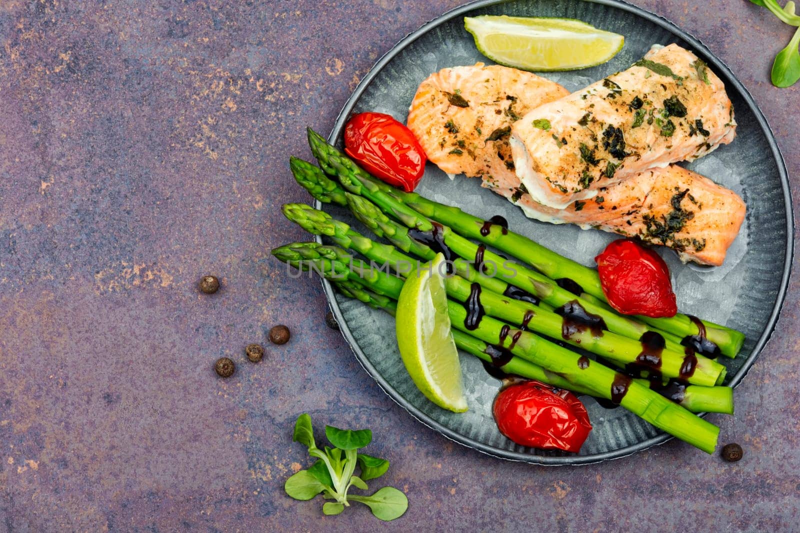 Tasty dish of trout, asparagus and tomato. Baked salmon. Space for text.