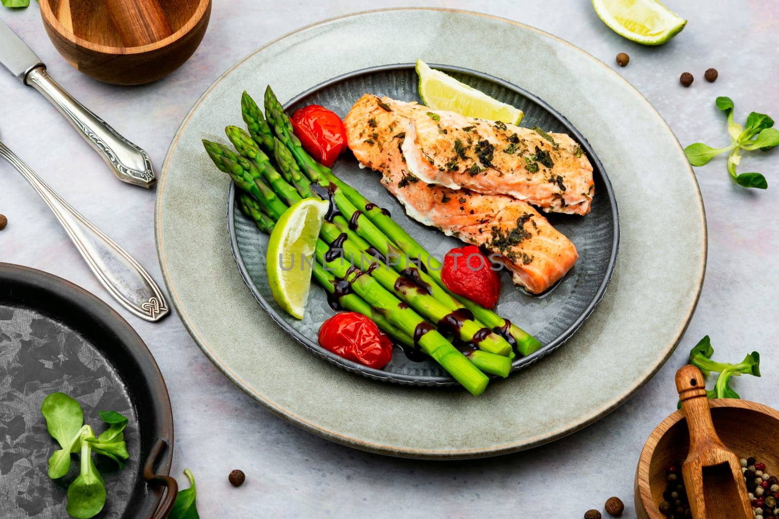 Tasty dish of trout, asparagus and tomato. Baked salmon. Space for text.