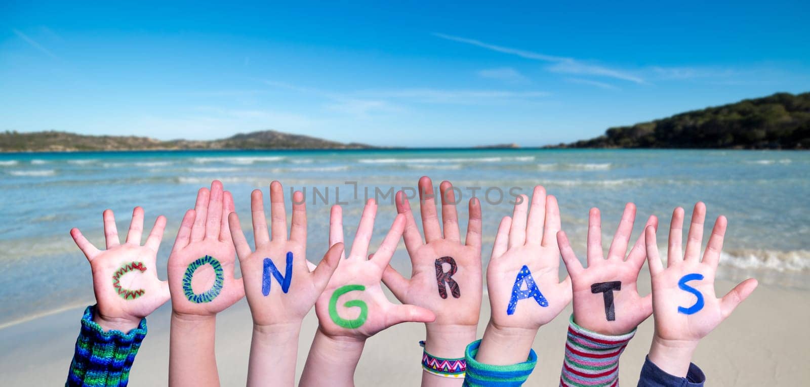 Children Hands Building Colorful English Word Congrats. Summer Ocean, Sea And Beach As Background