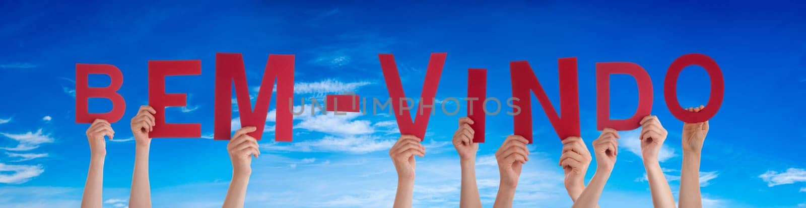 People Or Persons Hands Building Portuguese Word Bem-Vindo Means Welcome. Blue Sky As Background.