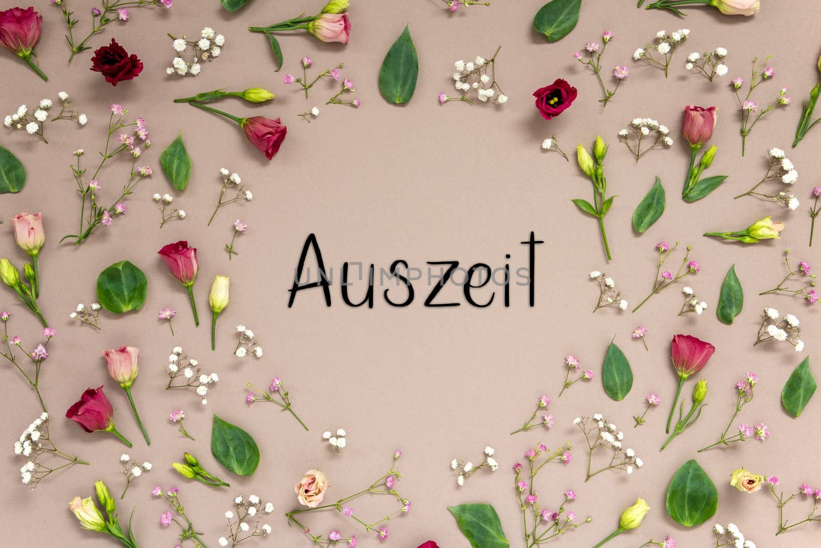 Flower Arrangement With German Text Auszeit Means Downtime. Colorful Spring Blossoms And Flowers Like Roses Building A Frame. Flat Lay With Brown Paper Background