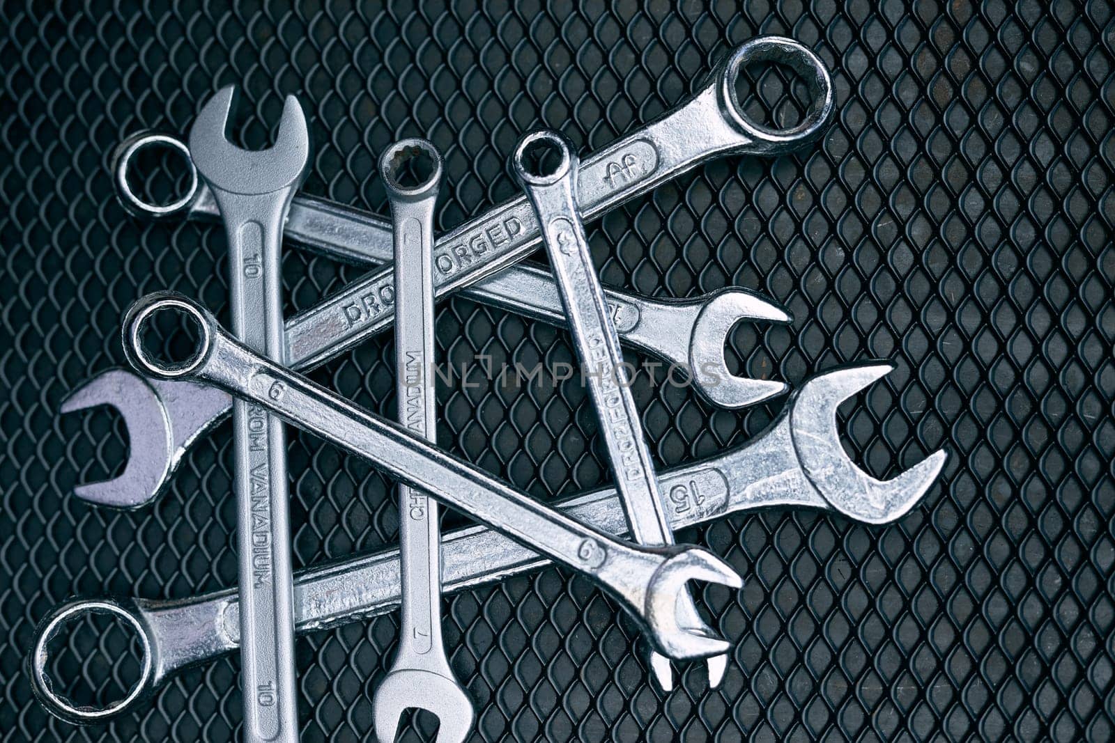Set of chrome wrenches on steel surface. Mechanic tools for maintenance. Hardware tools to fix. Technical tools background