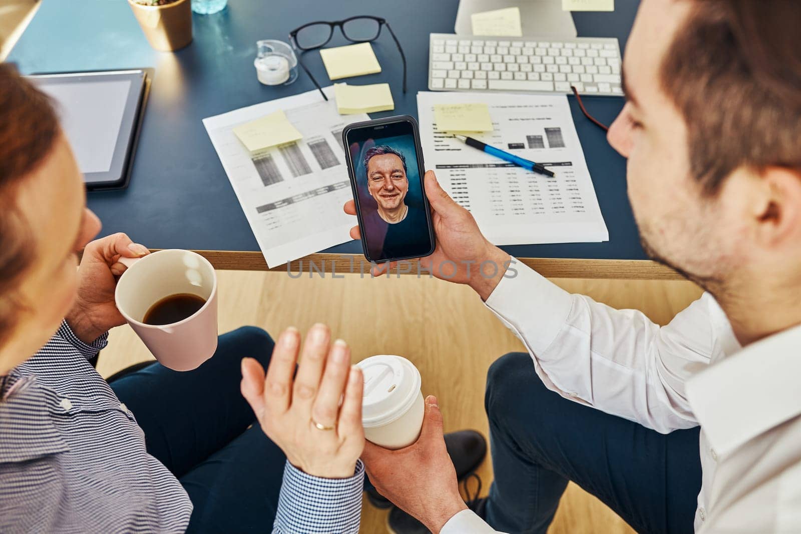 Business colleagues having video call discussing financial data working together in office. People entrepreneurs working with charts and tables on computer. Team working together. Workmates talking about project