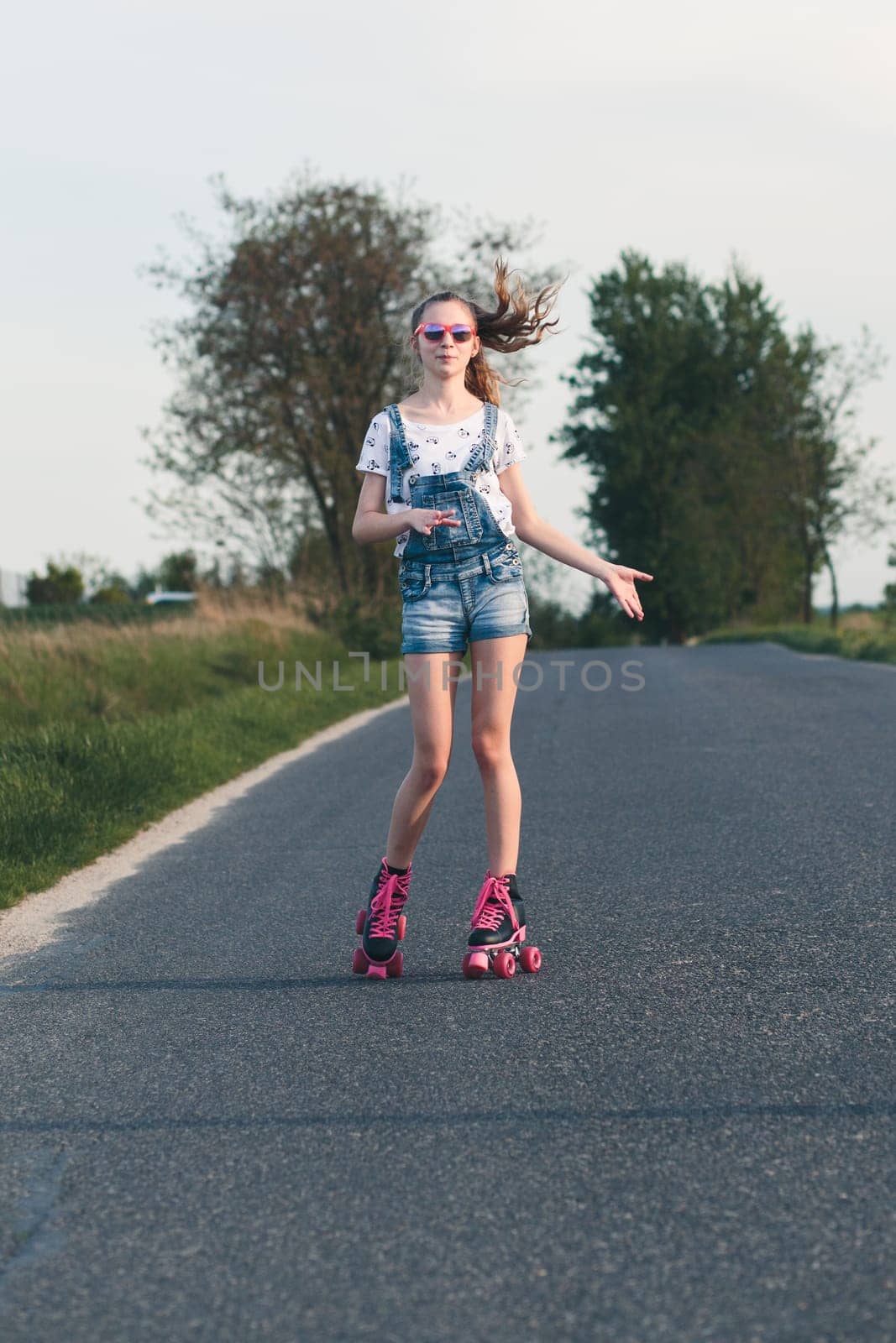 Young girl riding on roller skates. Real people, authentic situations