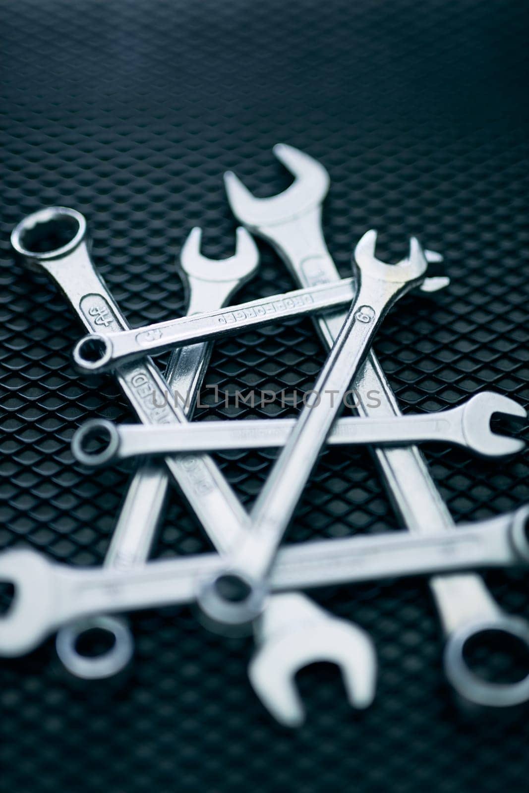 Set of chrome wrenches on steel surface. Mechanic tools for maintenance. Hardware tools to fix. Technical tools background