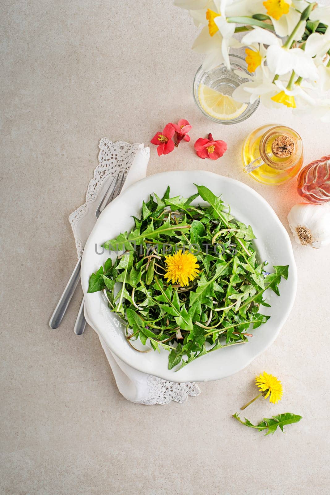 Fresh dandelion salad with dressing. Healthy spring food concept